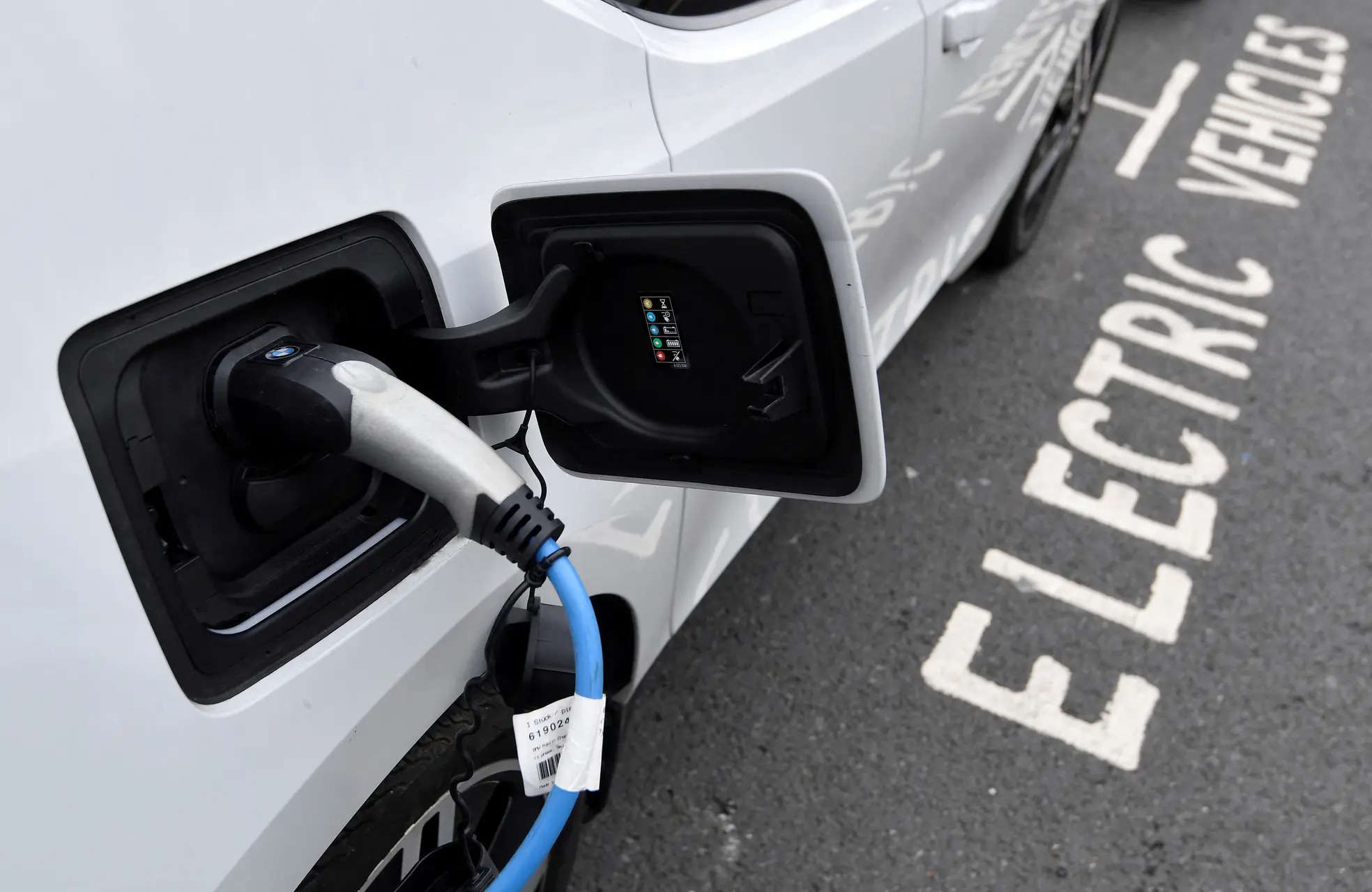 An electric car charges at an EV charging point on the London road